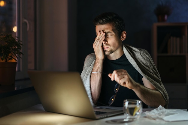 Overworked man treating flu at home