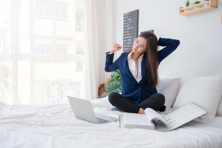 फोटो overworked and stressed young asian woman working on laptop computer and document