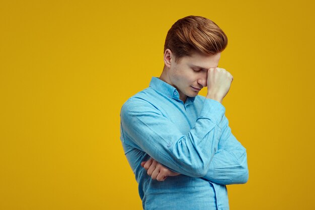 Overworked student closes eyes tries to concentrate and continue to work