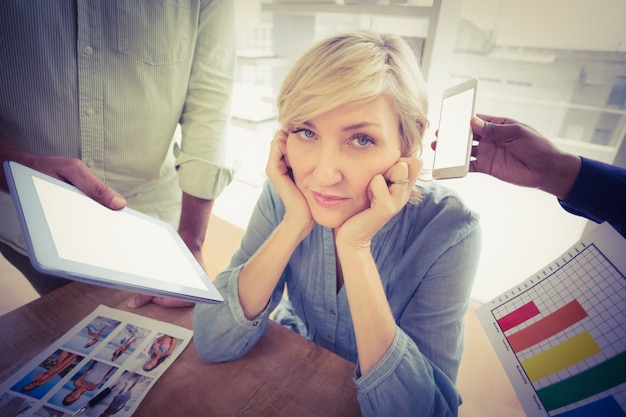 Overwrought businesswoman covering her ears