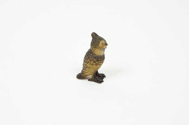 Owl mini figure isolated on white background. Plastic animal toys.