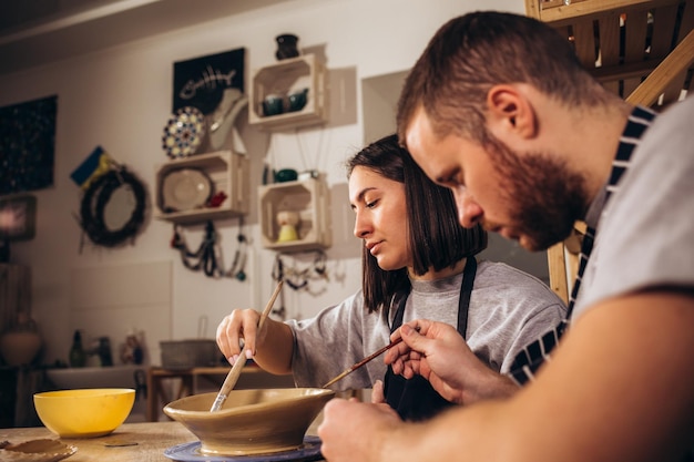 Own cup Young couple feeling satisfied while leaving pottery master class with their own cup