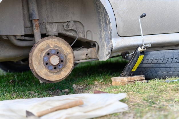 Photo own repair of car drum brake himself. repair of broken car drum brake disassembled outdoor