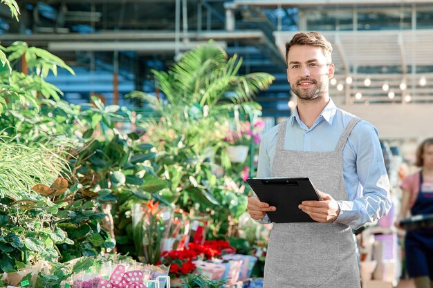 Owner of a flower shop with a clipboard