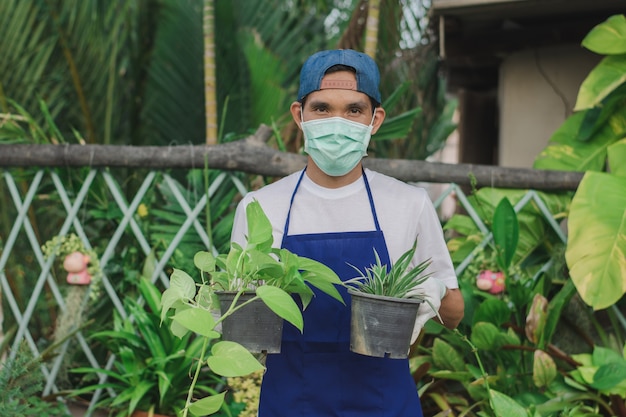 Owner shop ornamental plant holding pot in shop