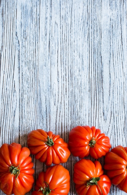 Ox heart tomatoes, on rustic wooden table