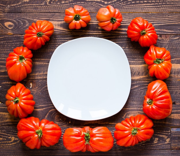 Ox heart tomatoes, on rustic wooden table