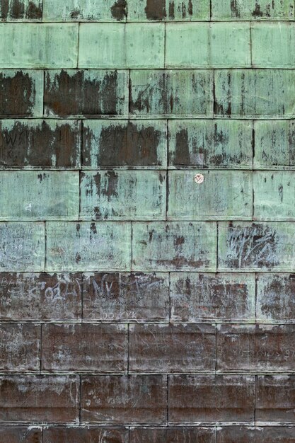 Photo oxidized copper folded sheet metal on roof copper wall texture background with marks and scrawls