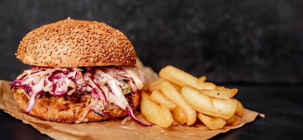 oxtail burger with cabbage fries on a stone table