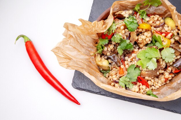 Oxtails with ptim and vegetables wrapped in craft paper