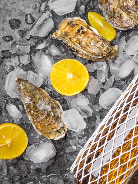 Oyster on ice lemon slices wine bottle Delicatessen and gourment food rich in iodine antioxidants zinc