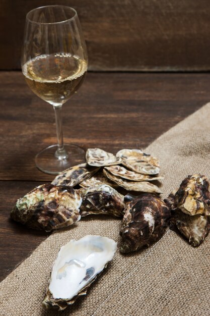 Oysters and glass of wine on table