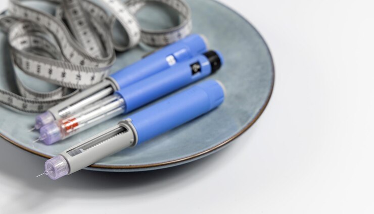 Photo ozempic insulin injection pen for diabetics and weight loss on a plate with a measuring tape