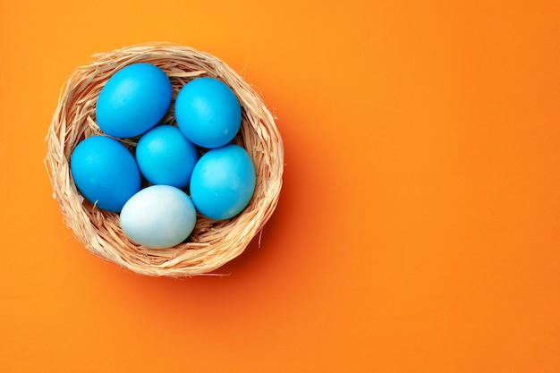 Paaseieren in een nest op oranje close-up