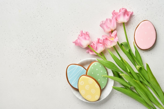 Paastafel met bloemendecor en bord met paaskoekjes