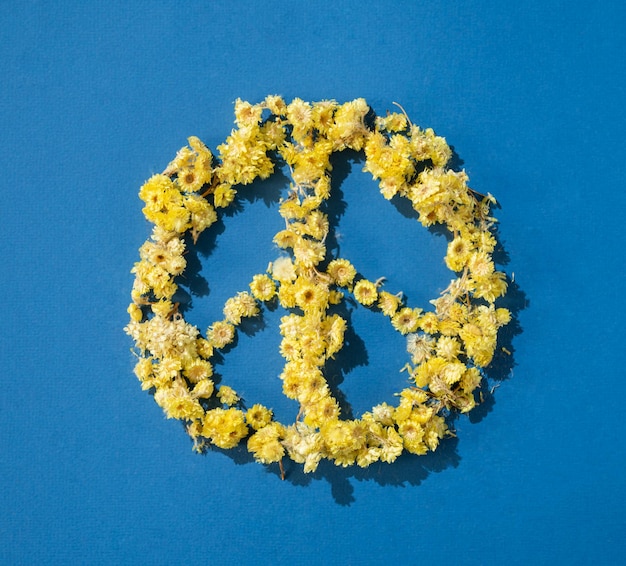 Pacific symbol is made of yellow flowers on a blue background The concept of the flag of Ukraine Support and peace in Ukraine Top view