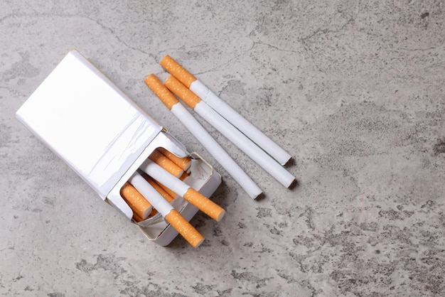 Pack of cigarette over grey rustic background White mockup top view