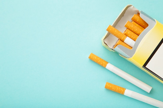 Pack of cigarettes on blue background. No smoking.