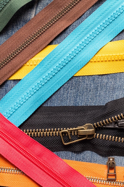 Pack of colorful plastic and metal zipper stripes close up