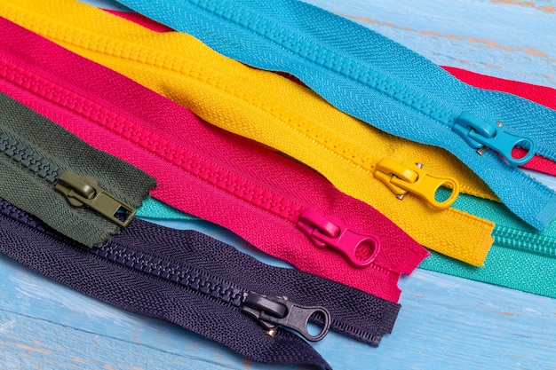 Pack of colorful plastic and metal zippers stripes