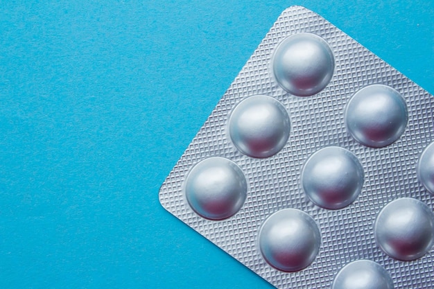 A pack of pills on a blue background.