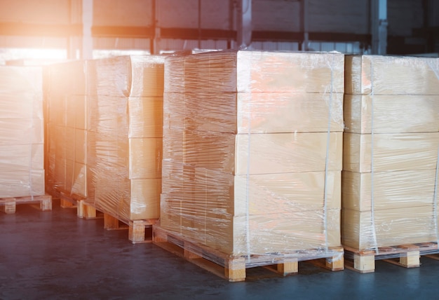 Package boxes wraaped plastic film on pallets in storage\
warehouse cargo shipping warehouse