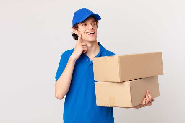 Package deliver man smiling happily and daydreaming or doubting