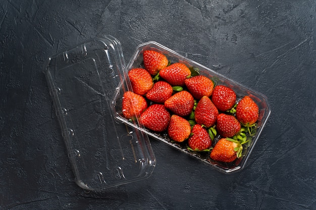 Package of ripe strawberries, supermarket. 