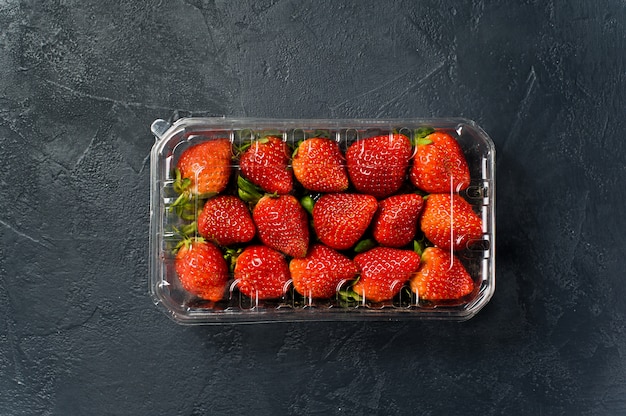 Package of ripe strawberries, supermarket. 