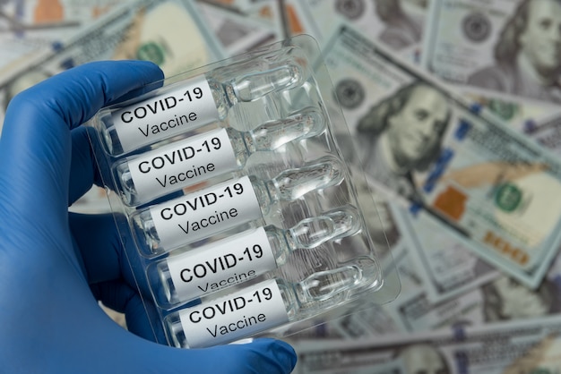 Packaging of ampoules with the vaccine COVID-19 in hand. Close-up.