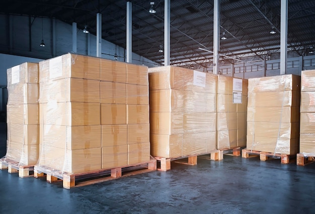 Photo packaging boxes wrapped plastic film on pallets in storage warehouse supply chain shipping warehous