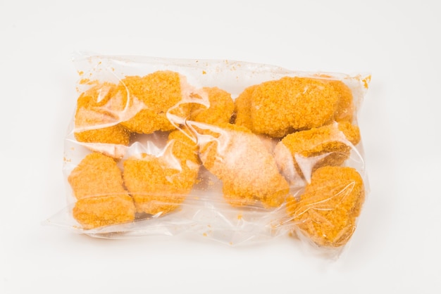 Photo packaging tasty nuggets on a white background.