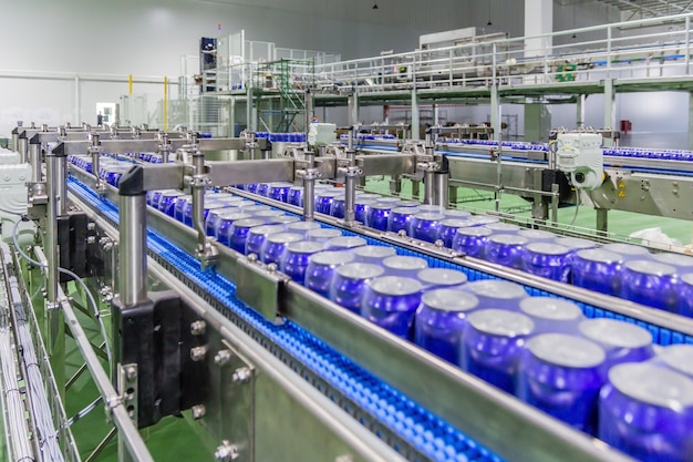 Packed cans on the conveyor belt in beverage factory