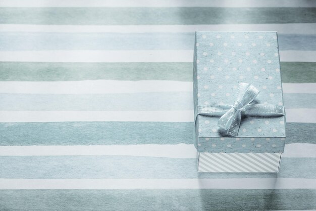 Packed present box on blue striped table cloth holidays concept