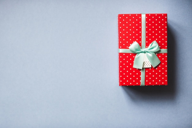 Packed red present with bow on blue background