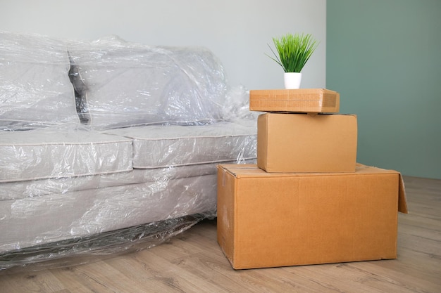 Packed sofa and cardboard boxes in the living room The concept of moving