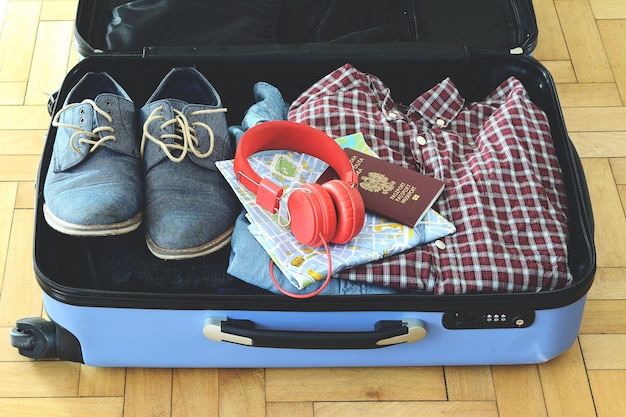 Packed suitcase of vacation items