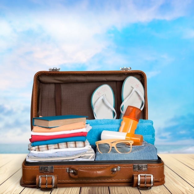 Packed vintage suitcase full of vacation items