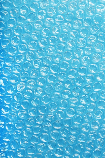 Packing bubble wrap for parcels on a blue background in full screen