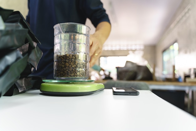 Packing roasted coffee beans to plastic bag