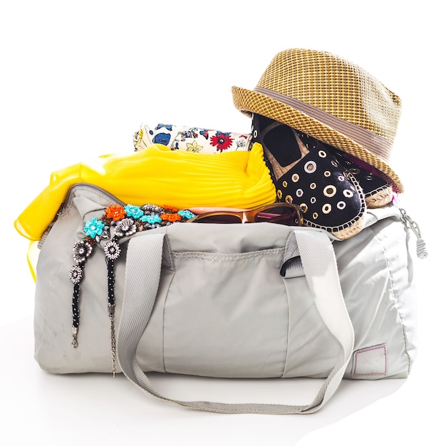 Packing suitcase for trip isolated on white