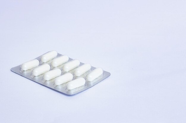 Packing of white tablets on blue background