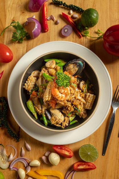 Pad Kee Mao Seafood Тайская еда на деревянном столе