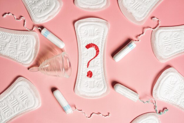 Pad menstrual cup tampon on a pink background The view is flat Concept of critical days menstruation High quality photo