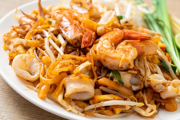 Pad Thai Seafood - Stir fried noodles with shrimps, squid or octopus and tofu in Thai style