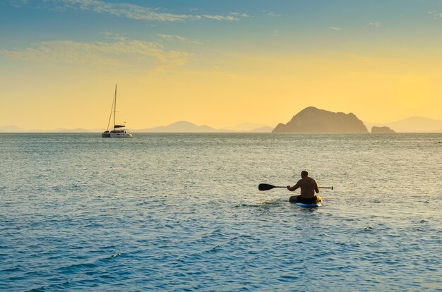 Paddle man in the sea Evening orange sky