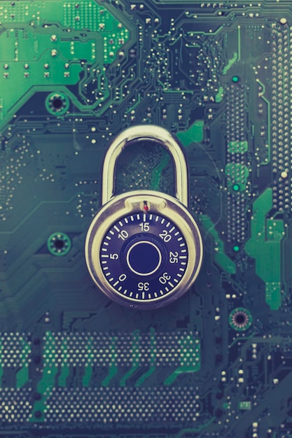 Padlock on a computer electronic circuit board data technology\
security concept