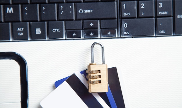 Padlock and credit cards on the computer keyboard. credit card\
security