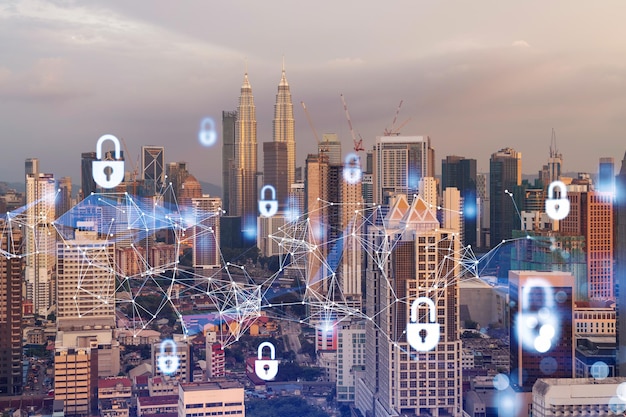 Padlock hologram on sunset panoramic cityscape of Kuala Lumpur Malaysia Asia The concept of cyber security intelligence in KL Multi exposure