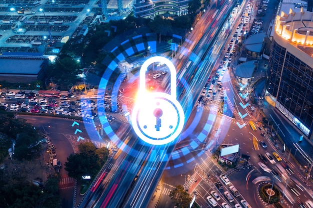 Padlock icon hologram on aerial view of road busy urban traffic highway at night Junction network of transportation infrastructure The concept of success in cyber security intelligence